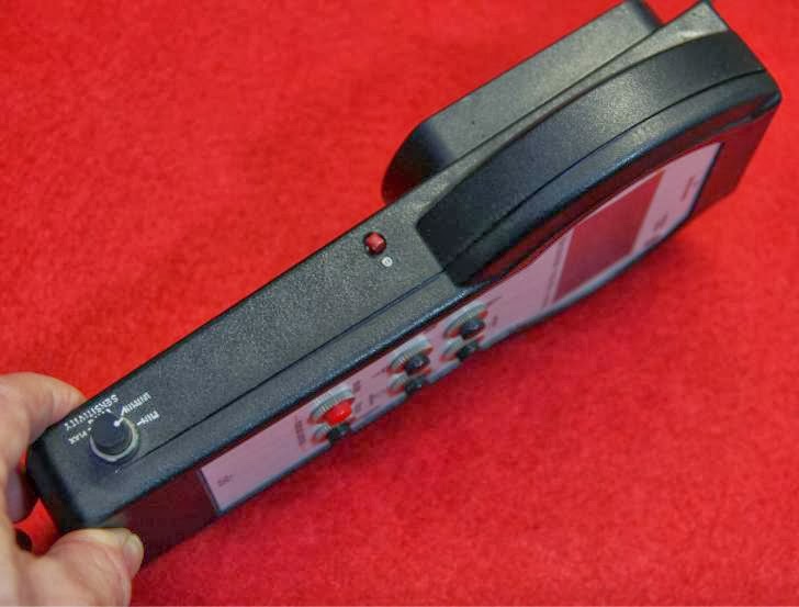 Side view of the power on button and sensitivity potentiometer